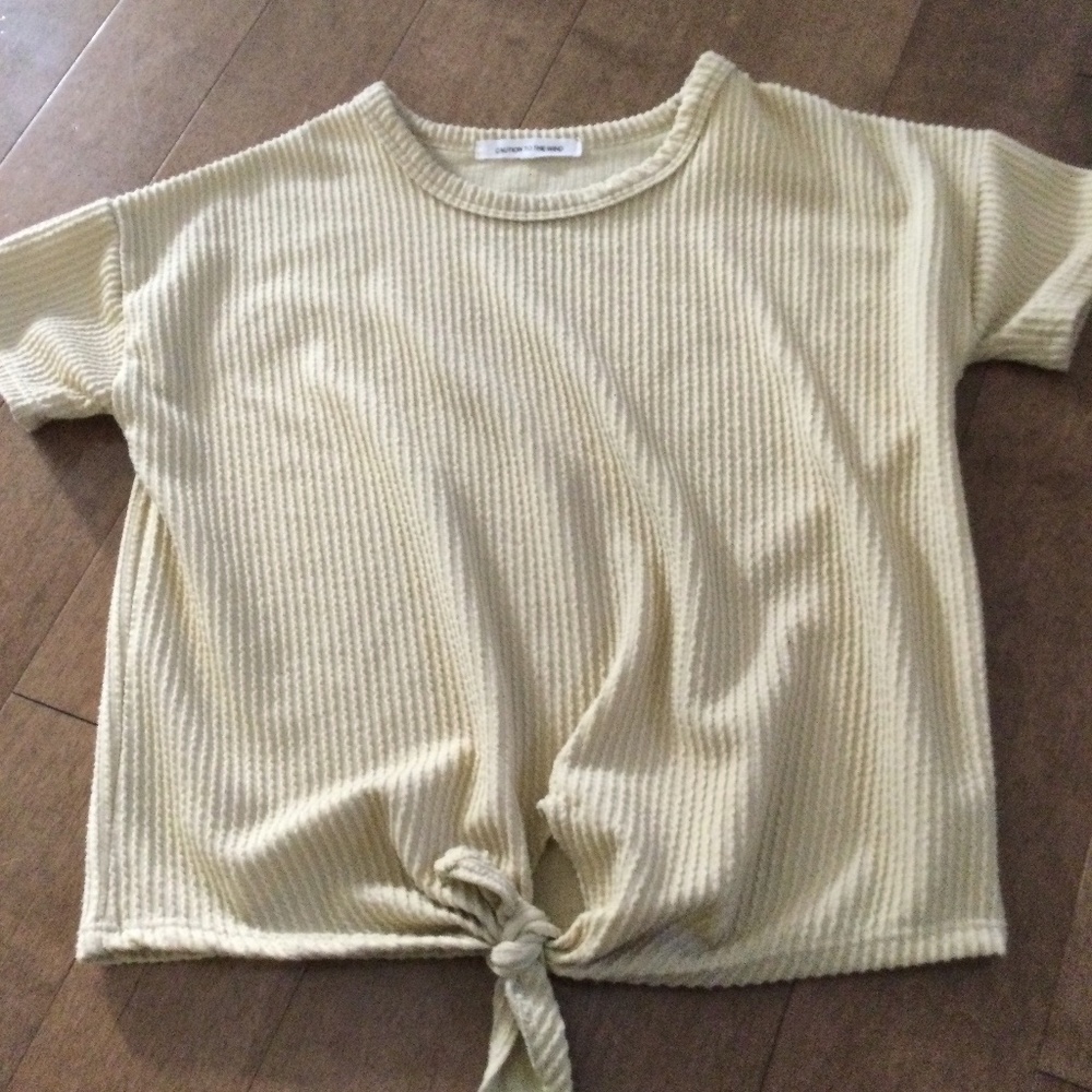 Light yellow textured tee shirt with a tie front